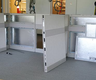 Workers install office cubicles 